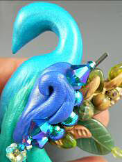 Clay peacock with glass beads